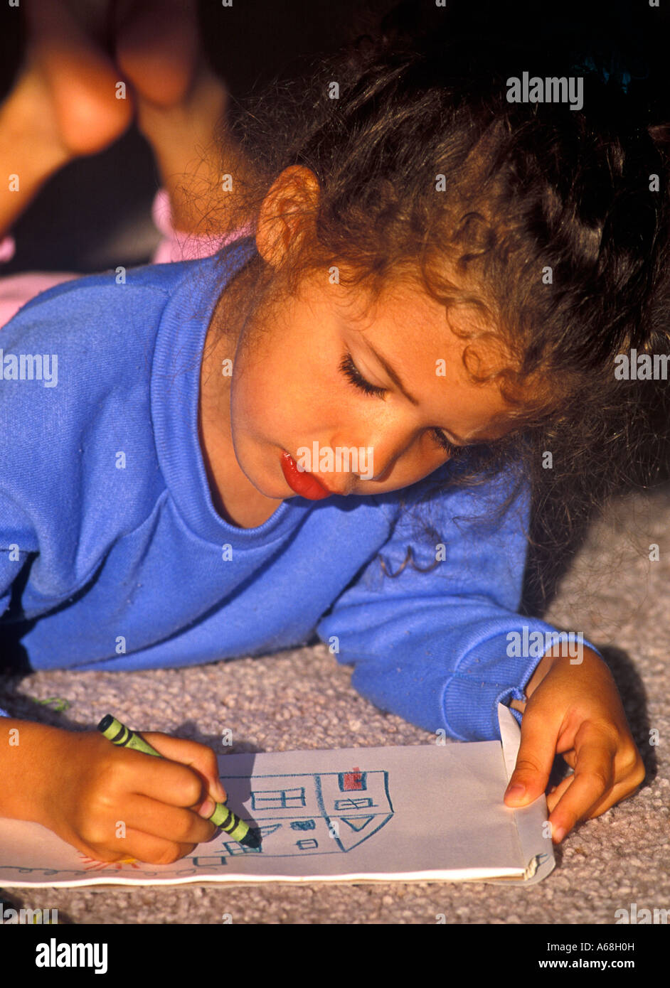 Pre schooler il disegno di una foto con matite colorate Foto Stock