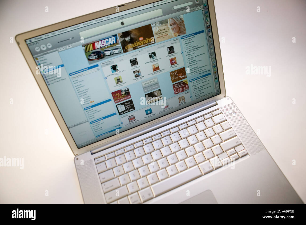 Computer portatile Apple powerbook su sfondo bianco visualizzando la pagina da iTunes online di musica e video store website Feb 2006 Foto Stock