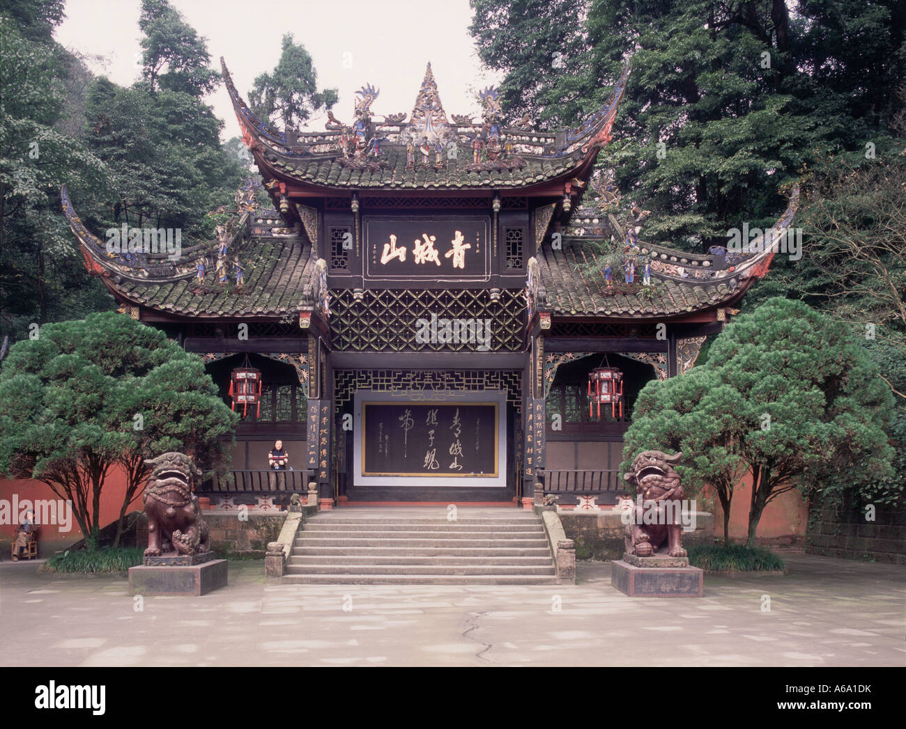 Cina, Qingcheng Shan (città verde montagna), ornati gateway anteriore al tempio di rinomato daoisti ritiro con gronda capovolta Foto Stock