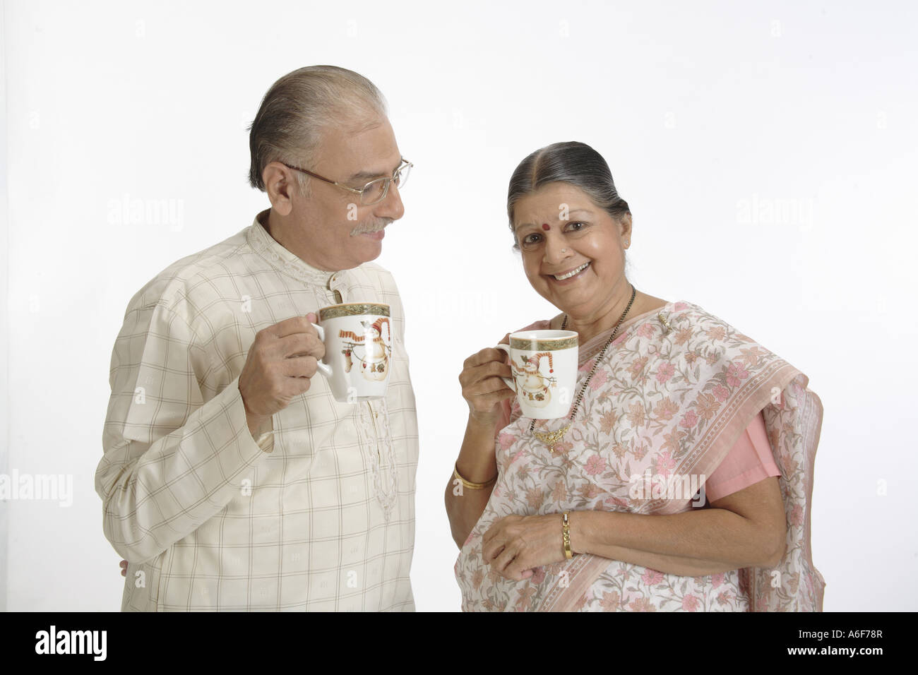 Vecchia coppia felice vecchio uomo che indossa Kurta pigiama specs  bicchieri old Lady indossando Saree Mangalsutra tazze da caffè nelle loro  mani Foto stock - Alamy