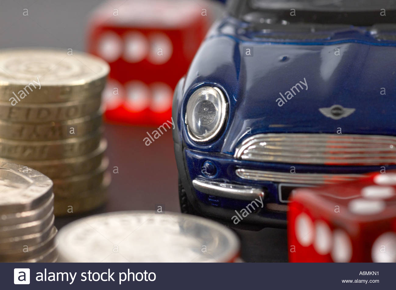 Un auto, denaro e dadi rossi Foto Stock