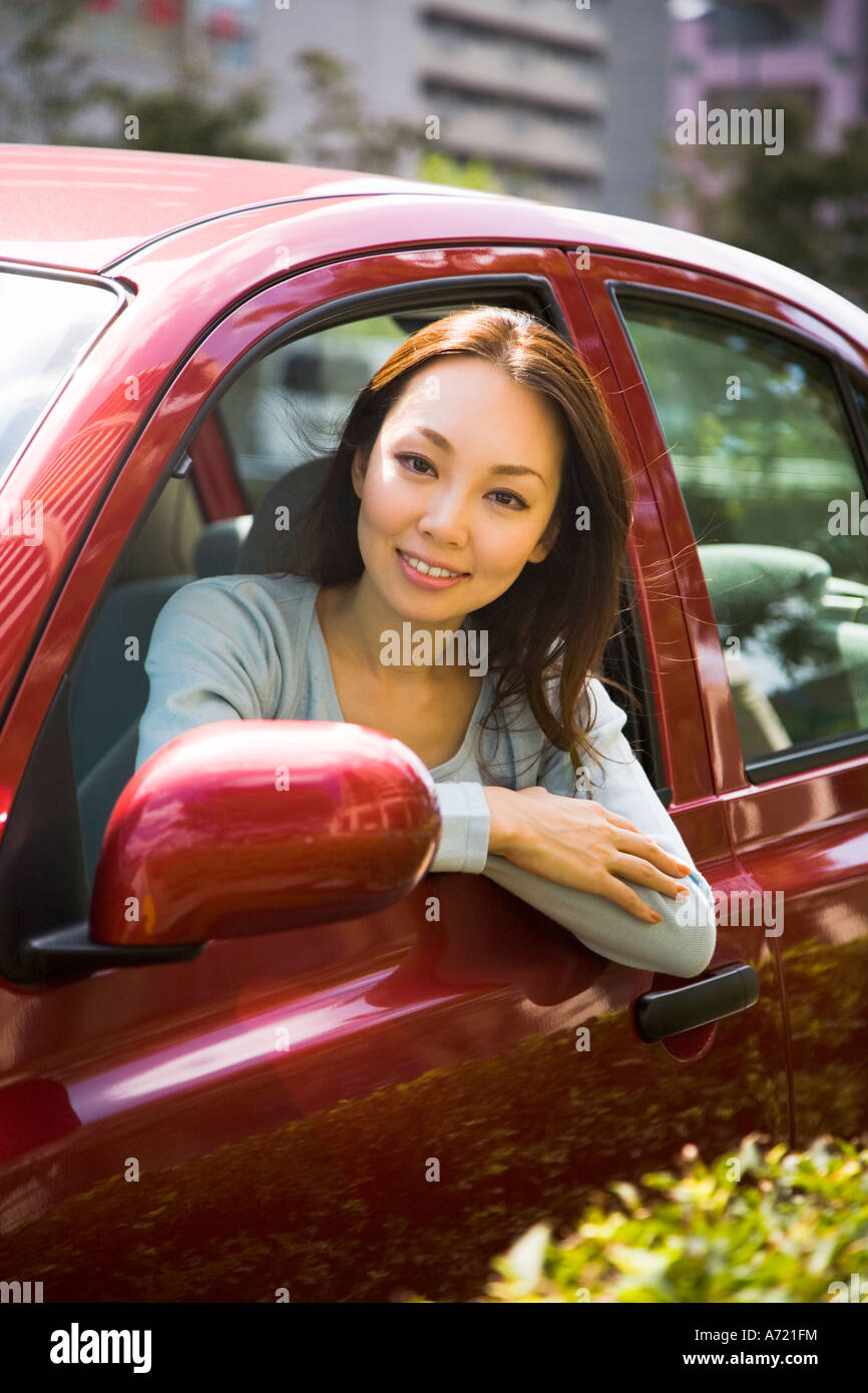 Giovane donna seduta nel sedile del passeggero in auto Foto Stock