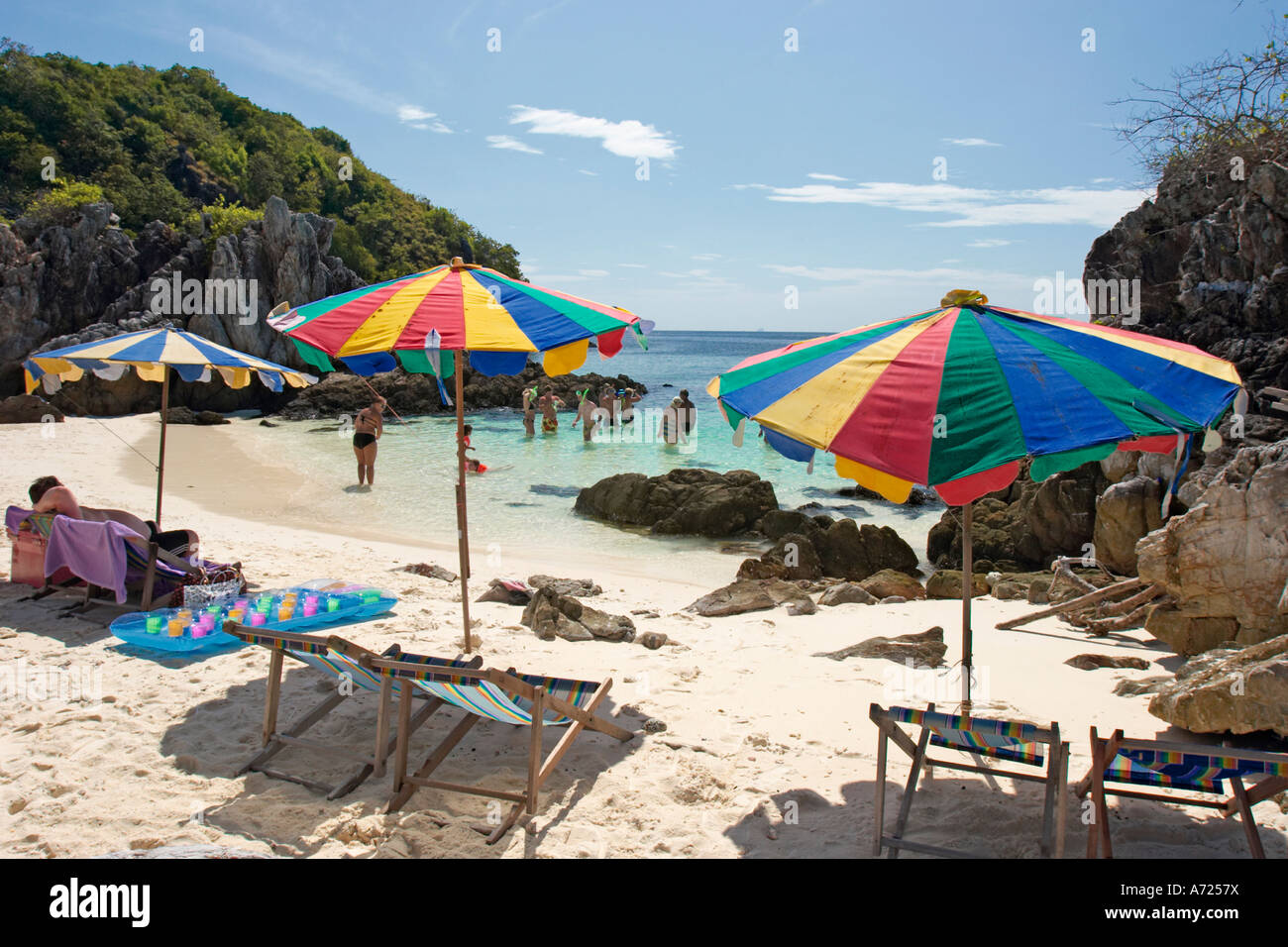 Sedie a sdraio e ombrelloni colorati sulla spiaggia di sabbia bianca. Koh Khai, una piccola isola corallina vicino a Phuket, Tailandia. Foto Stock