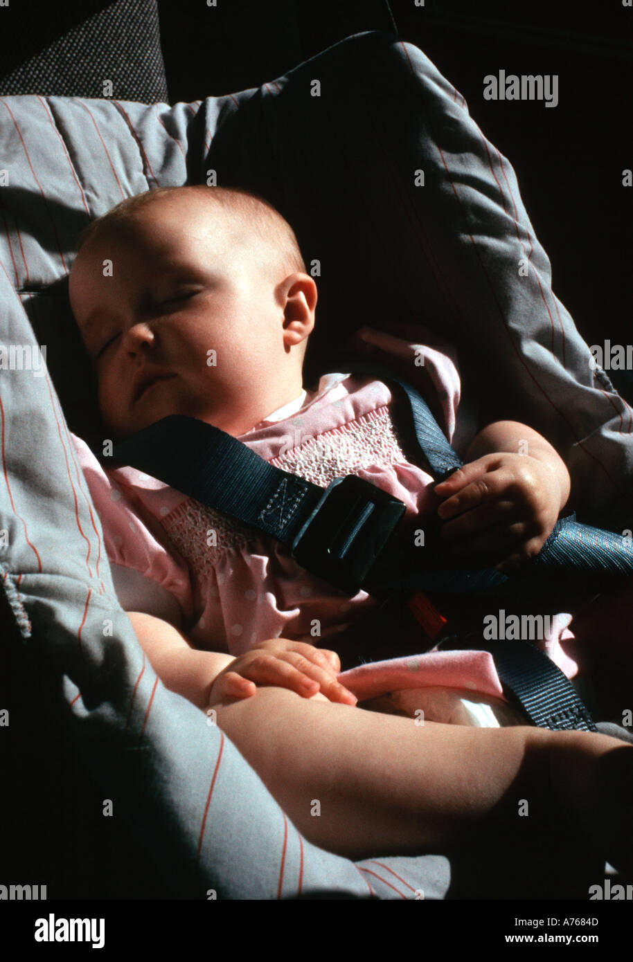 Il bambino addormentato in un seggiolino per bambini nella parte posteriore di un auto baby figlia del fotografo Foto Stock