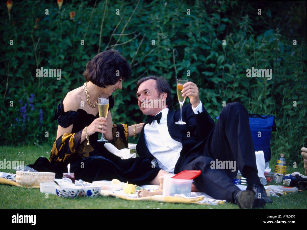 Un giovane picnic nel parco durante l'intervallo al famoso teatro dell'opera Glyndebourne nel Sussex England Foto Stock