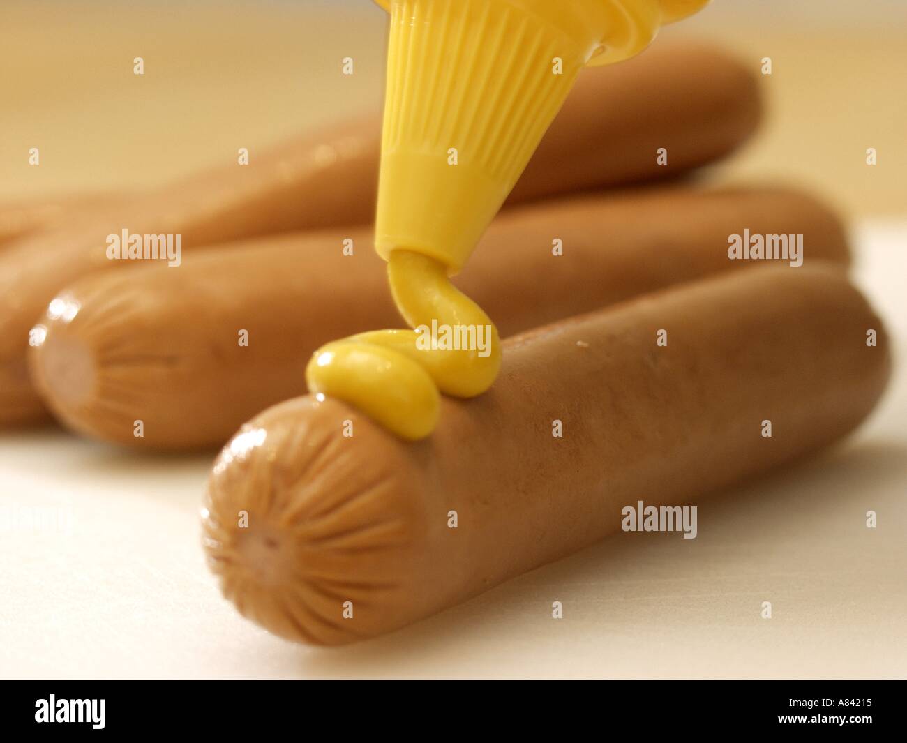 La spremitura di senape su un Hot Dog Foto Stock