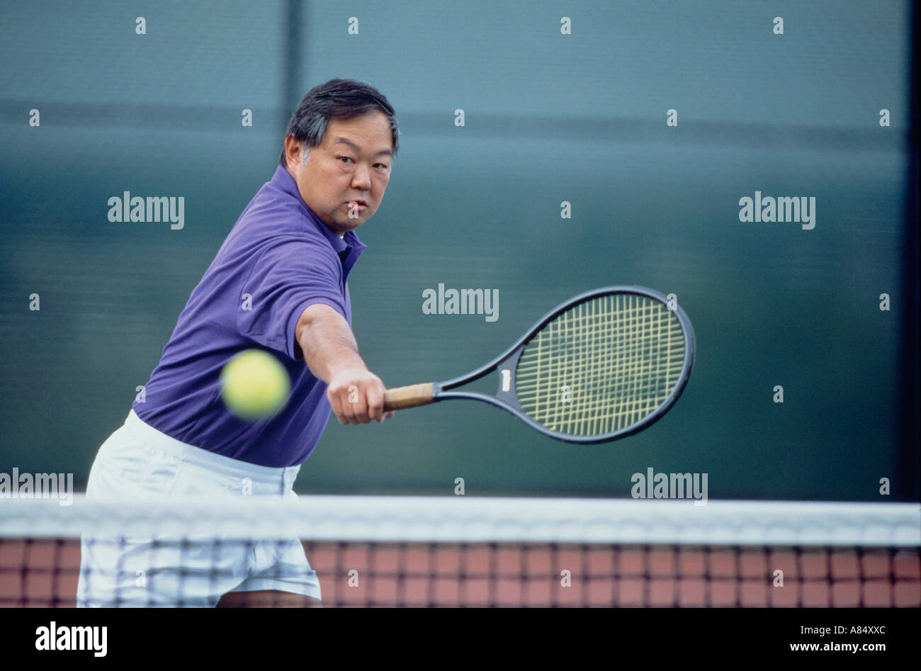 Mid-età uomo giocando a tennis. Foto Stock