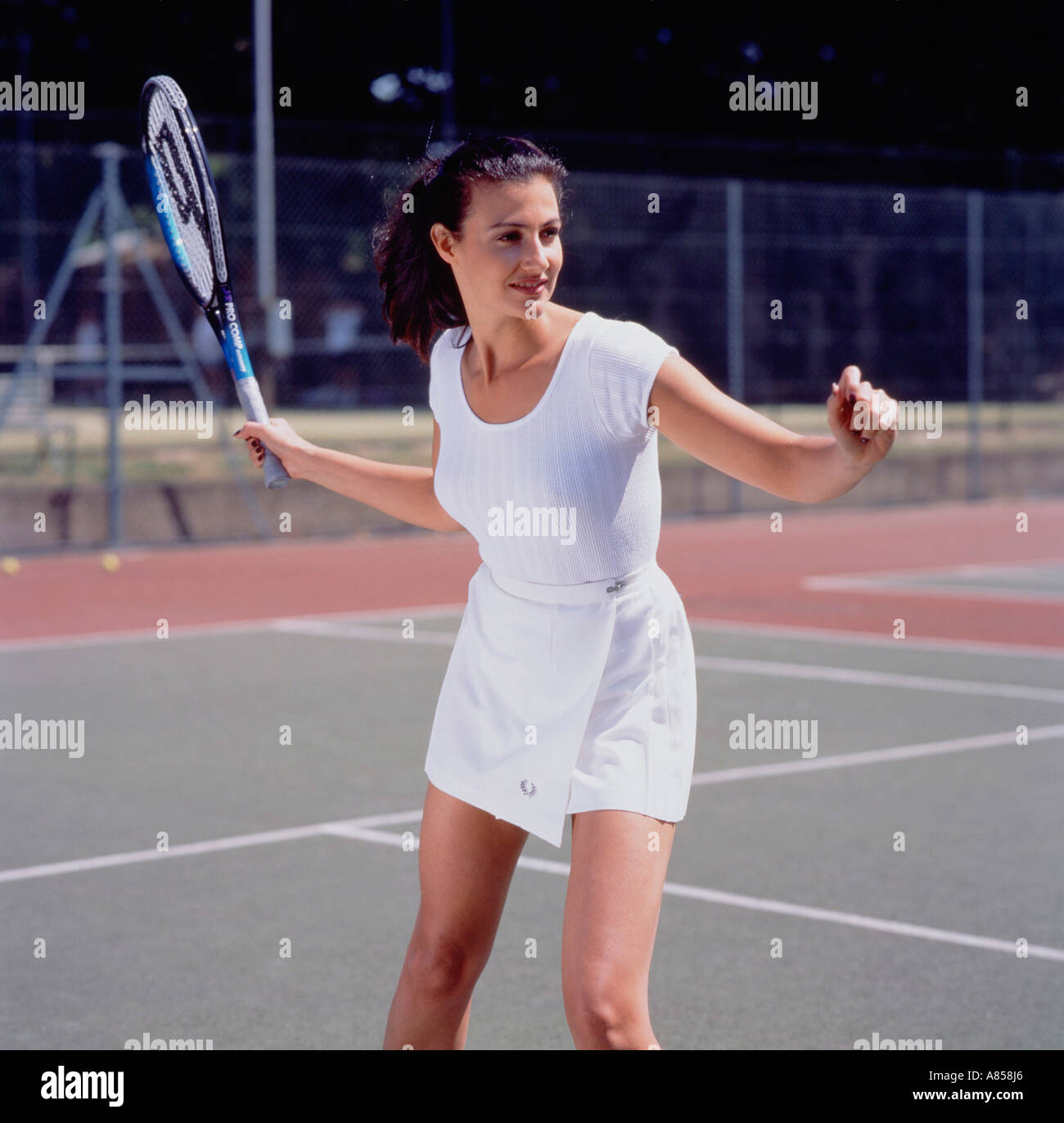 Giovane donna giocando a tennis su hard court. Foto Stock