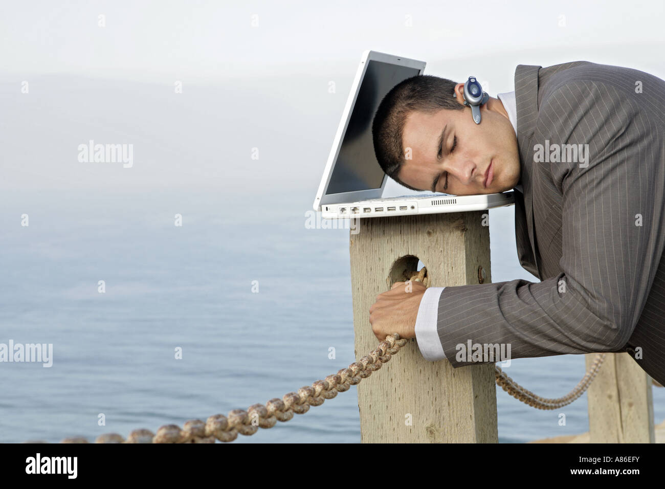 Vista di un uomo di dormire su un laptop. Foto Stock