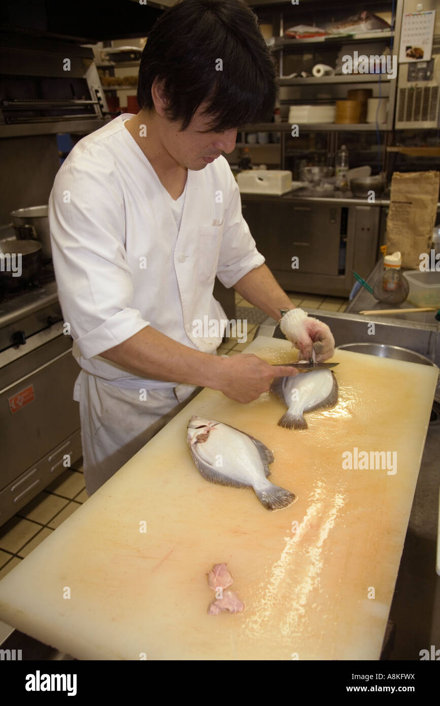 Sfilettatura di passera di mare per il sashimi in un ristorante giapponese Foto Stock