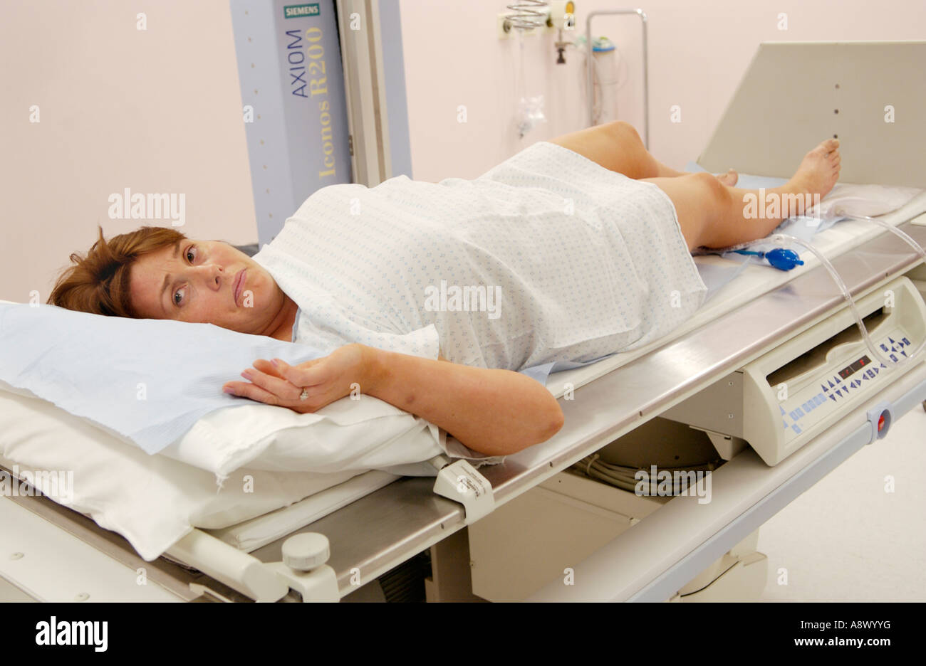 Donna con enema del bario sulla tavola di Siemens Medical Solutions Axiom Iconos R200 fluoroscopia l'unità di imaging ospedale privato REGNO UNITO Foto Stock