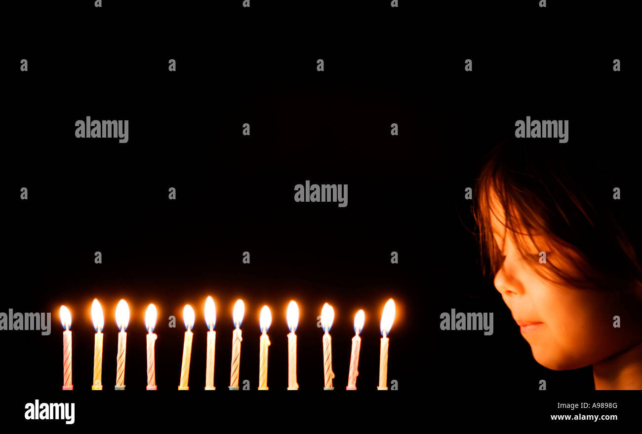 Ragazza di età compresa tra i 3 soffia out 12 candele Foto Stock