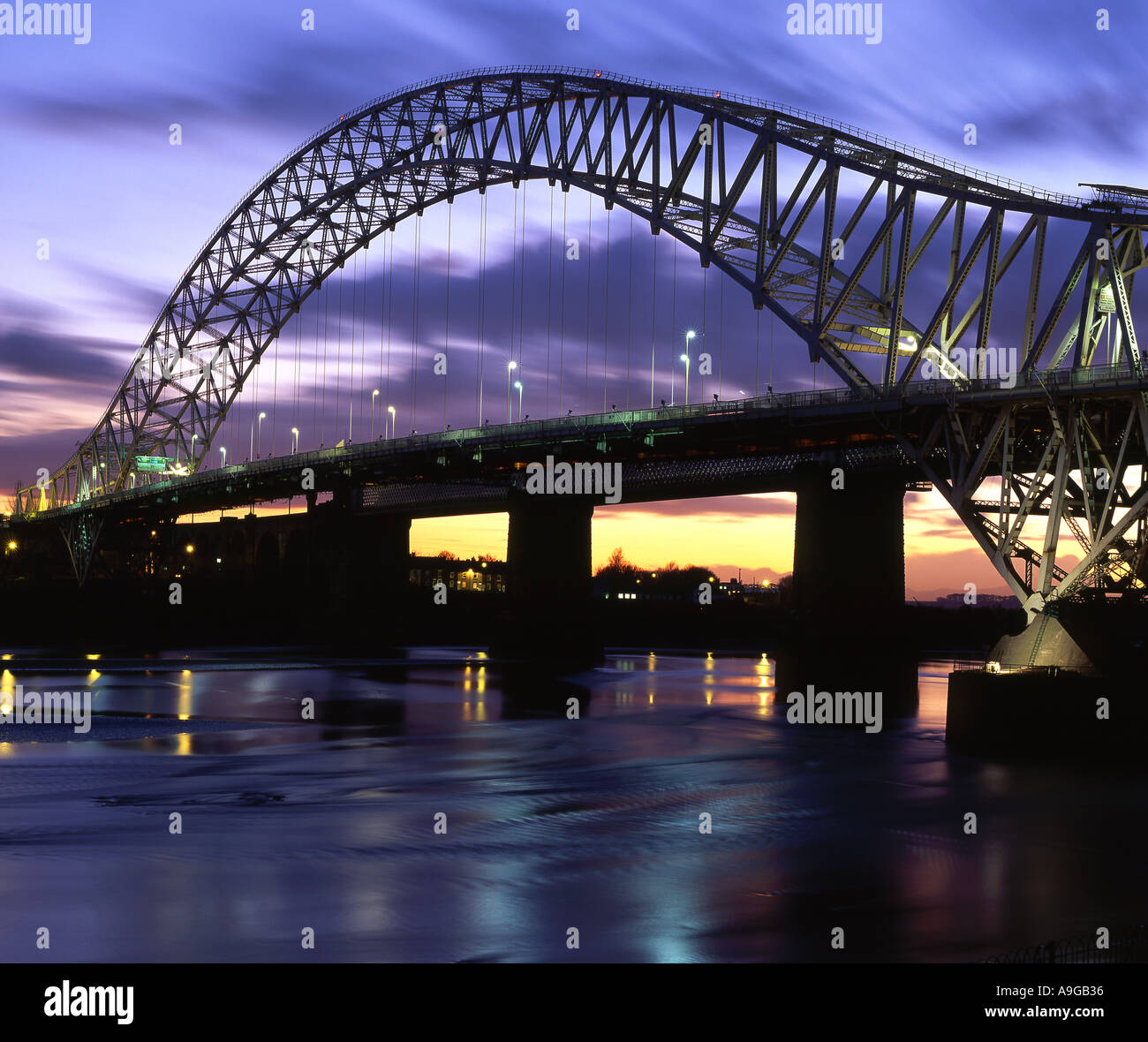 L'impianto di Runcorn e Widnes Roadbridge sul fiume Mersey di notte, Cheshire, Inghilterra, Regno Unito Foto Stock