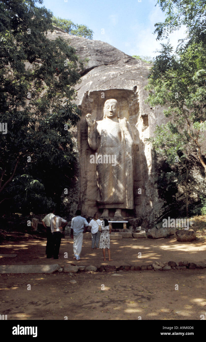 Gli abitanti dello Sri Lanka visita il 40ft roccia scolpita la statua di Buddha a Sasseruwa Foto Stock