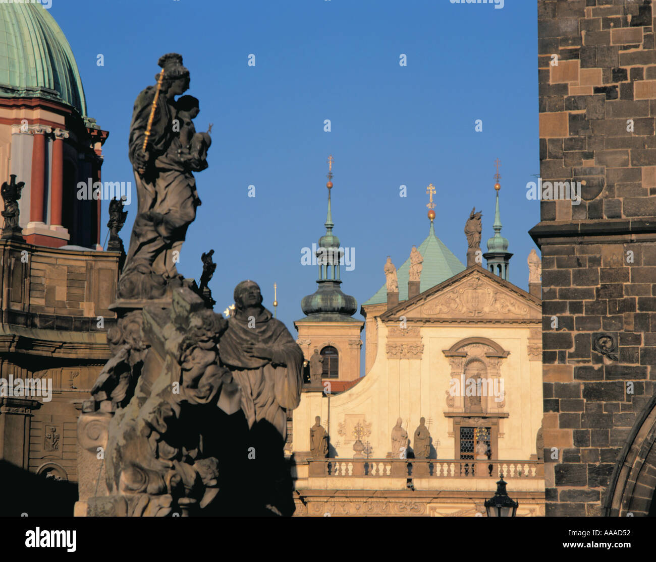 Sculture ornate in pietra su Karlûv Most (Ponte Carlo), con cupole della chiesa oltre, Praga, Repubblica Ceca. Foto Stock