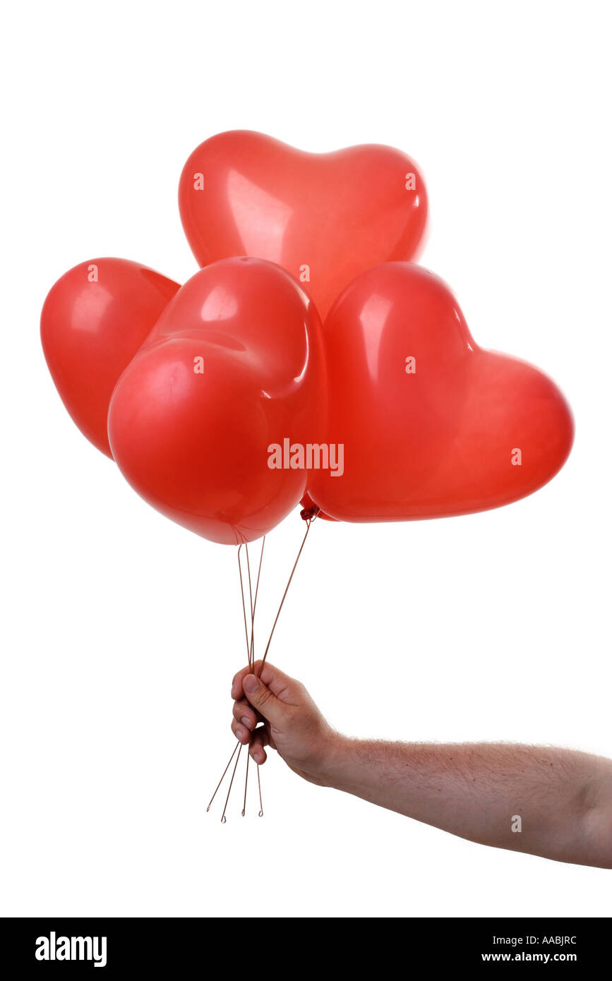 Mano con palloncini a forma di cuore Foto Stock