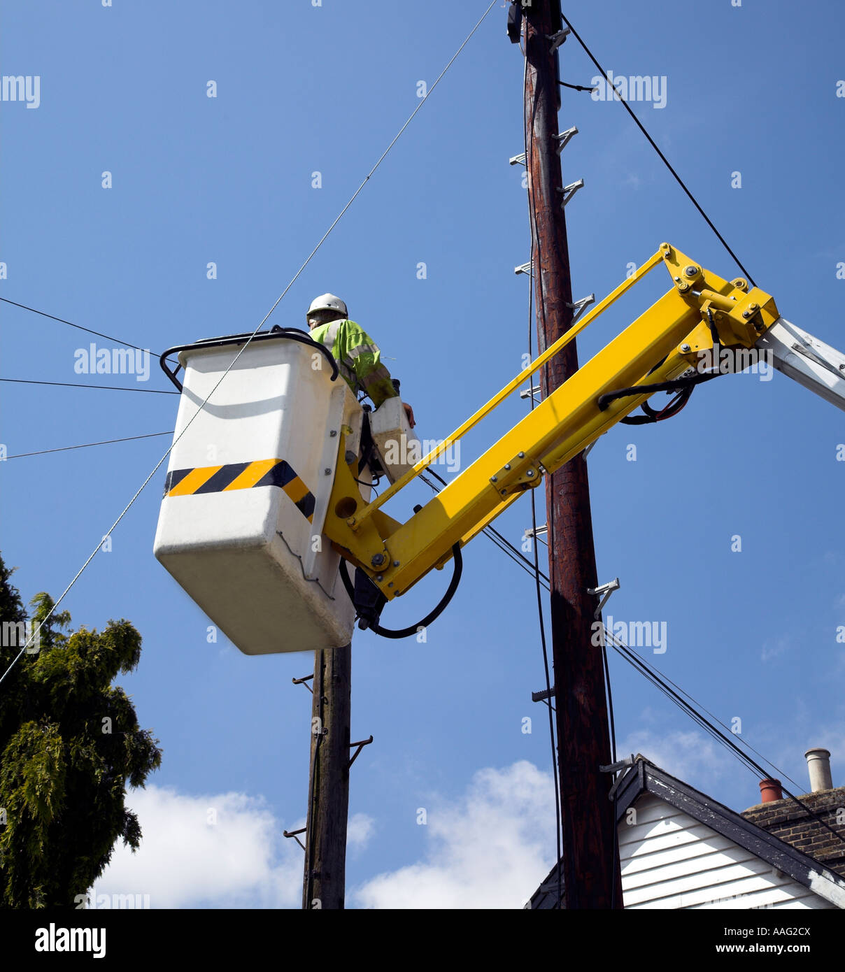Lavoratore di utilità in un sollevamento idraulico Riparazione di rotture di linee telefoniche. Foto Stock