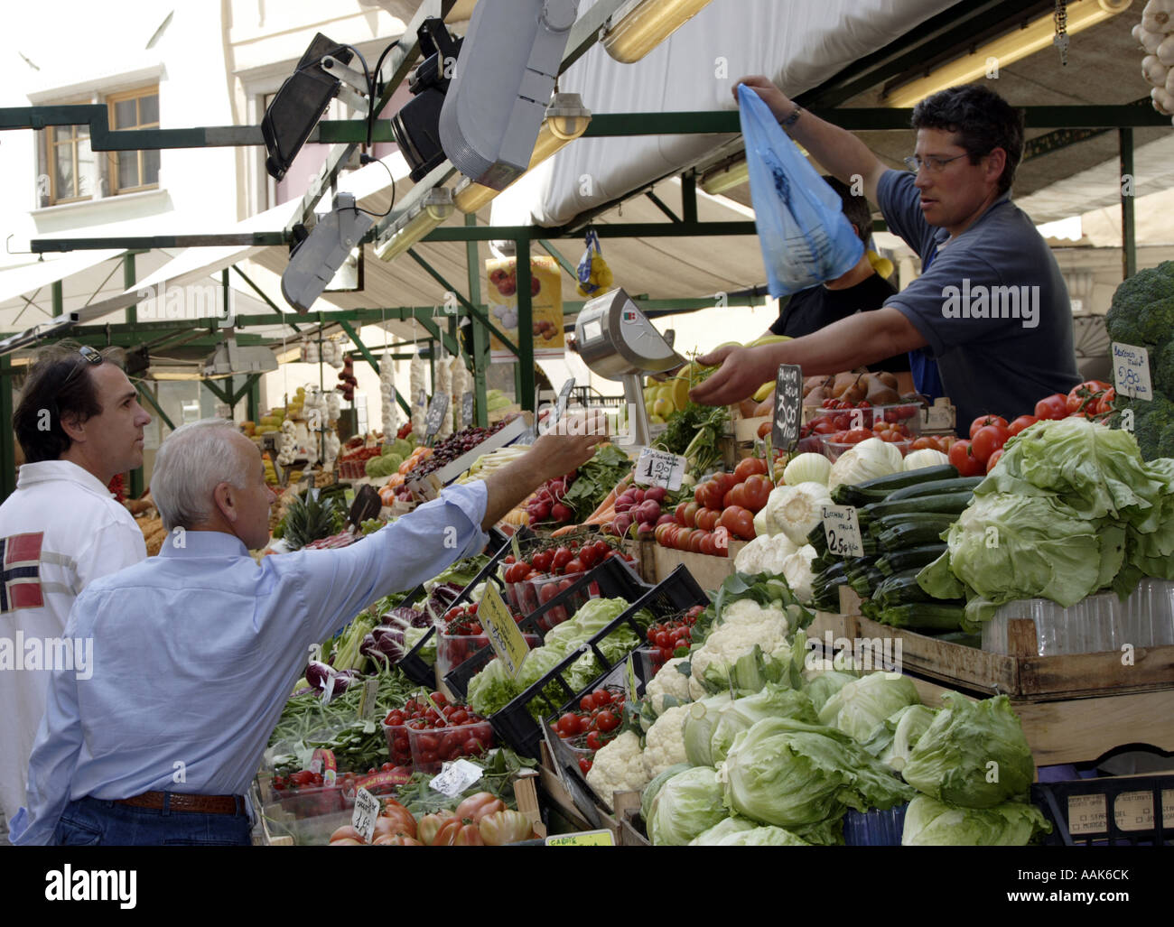 Bolzano (Bosen), Alto Adige, Italia: Gli acquirenti cercano frutta, verdura e altri prodotti alimentari in un mercato centrale all'aperto Foto Stock