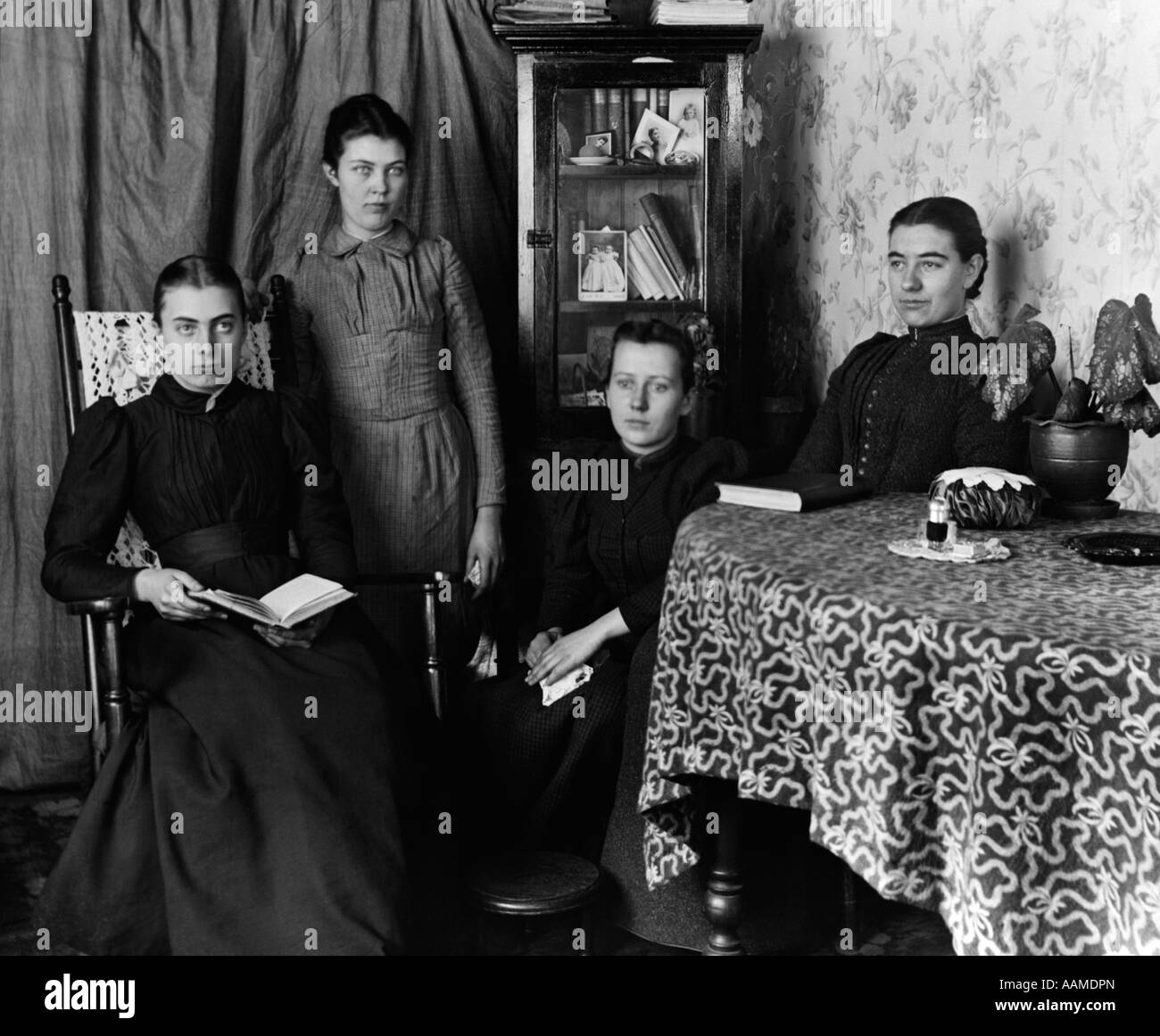 1890s 1895 svolta del secolo di un gruppo di quattro donne studenti laureati riuniti intorno al tavolo con i libri Foto Stock