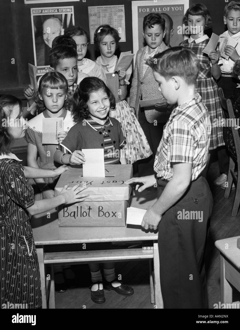 Anni Cinquanta 4A SCUOLA DEL GRADO DI SIMULAZIONE DI ELEZIONE agli studenti di mettere voti nelle urne Foto Stock