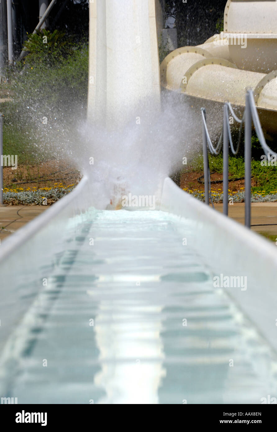 Schizzi di acqua da una persona lo scorrimento verso il basso l'acqua ride in un parco acquatico Foto Stock