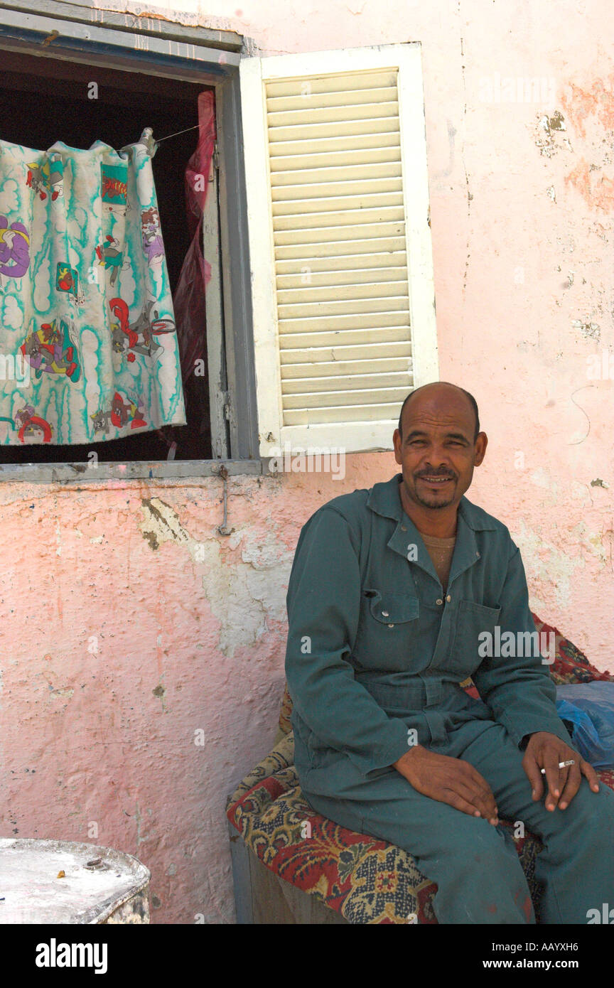 Egyptian uomo seduto sulla tavola con tappeto su di essa città vecchia ed Dahar regione Hurghada Foto Stock
