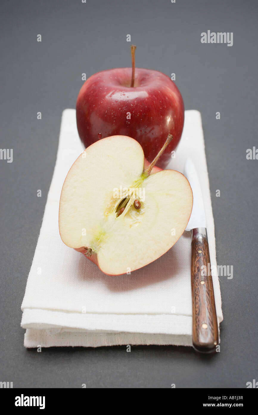 Due mele rosse varietà Stark intero e metà FoodCollection Foto Stock