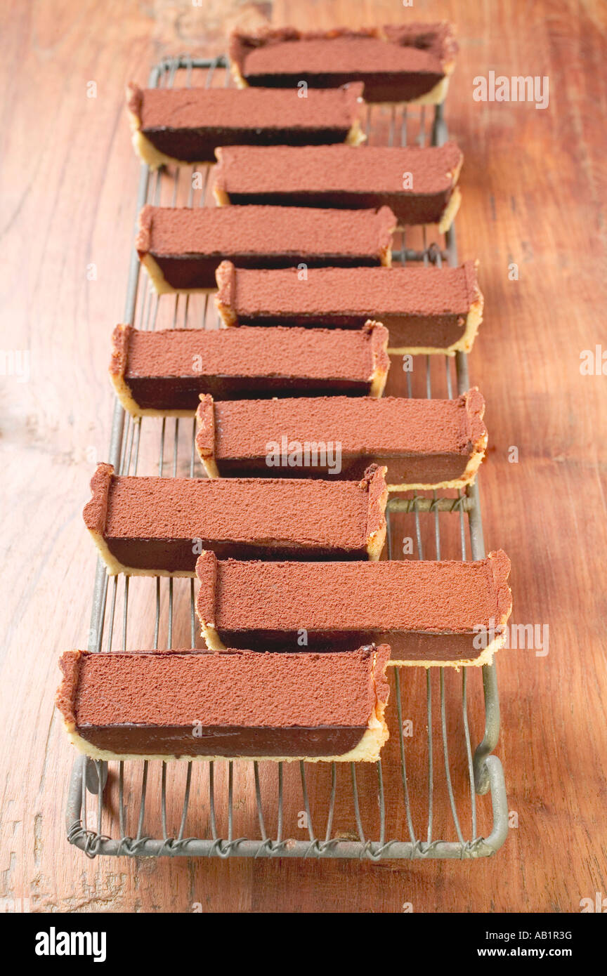 Rettangolare torta al cioccolato con polvere di cacao in pezzi FoodCollection Foto Stock