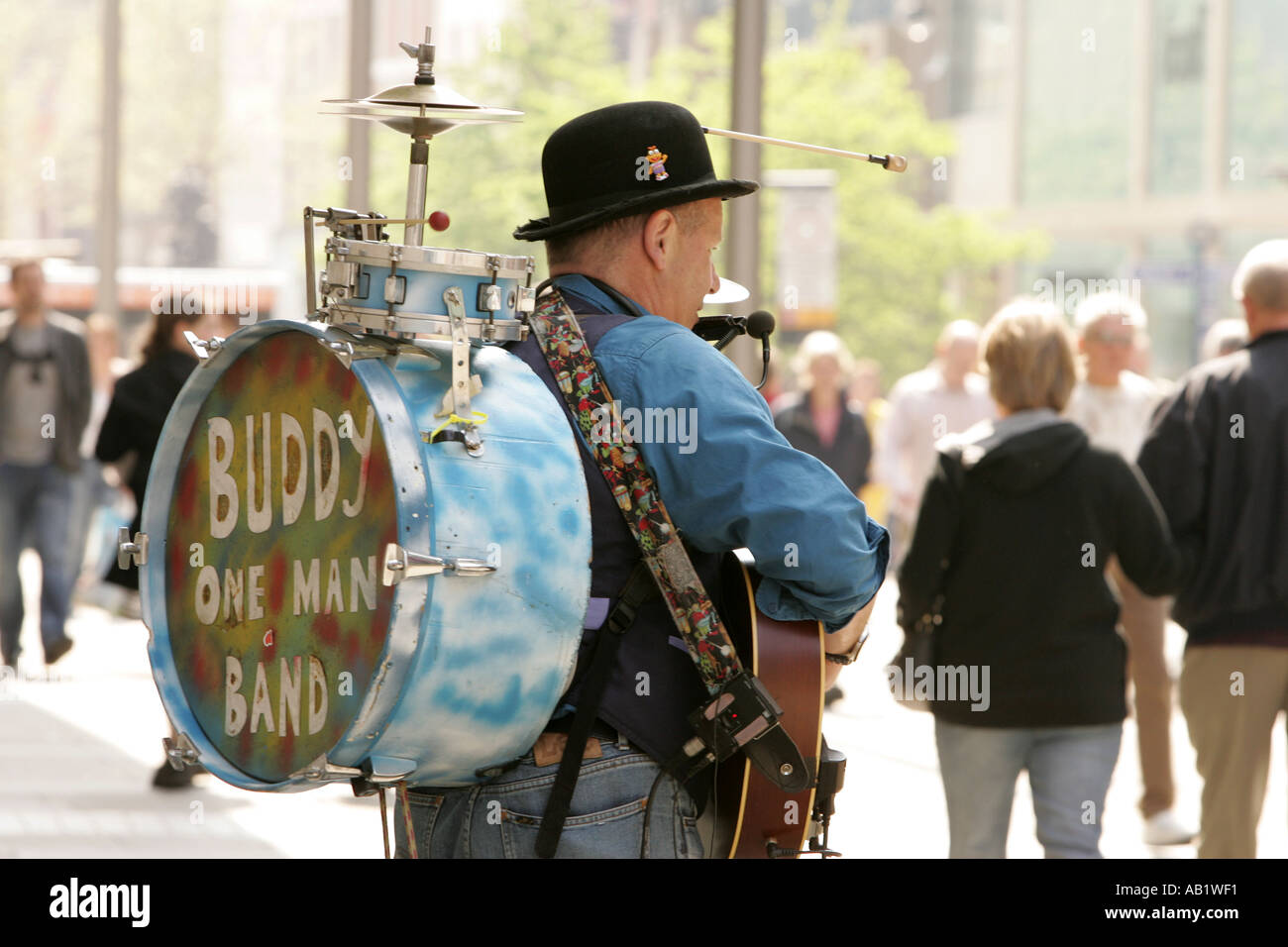 Musicista di strada one man band suonare la chitarra di concertina tamburo cembali Manchester City Centre country music urban spa di divertimenti Foto Stock