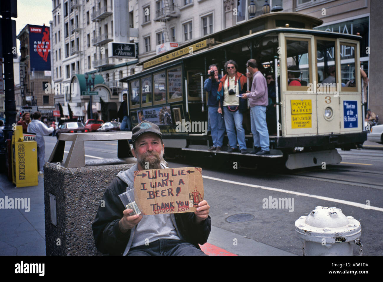 Veritiera Panhandler chiede per la birra di denaro a Union Square Funivia in background con turisti San Francisco CA Foto Stock