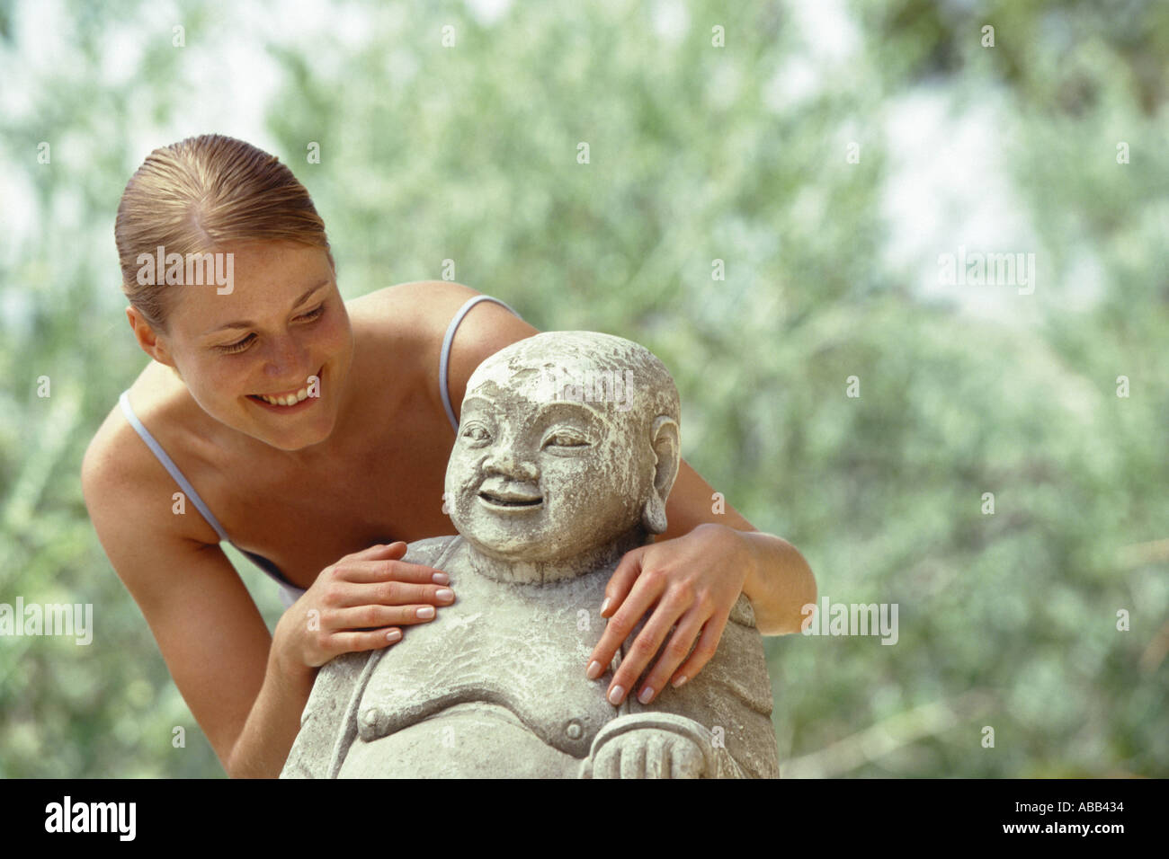 Donna con la statua del Buddha Foto Stock