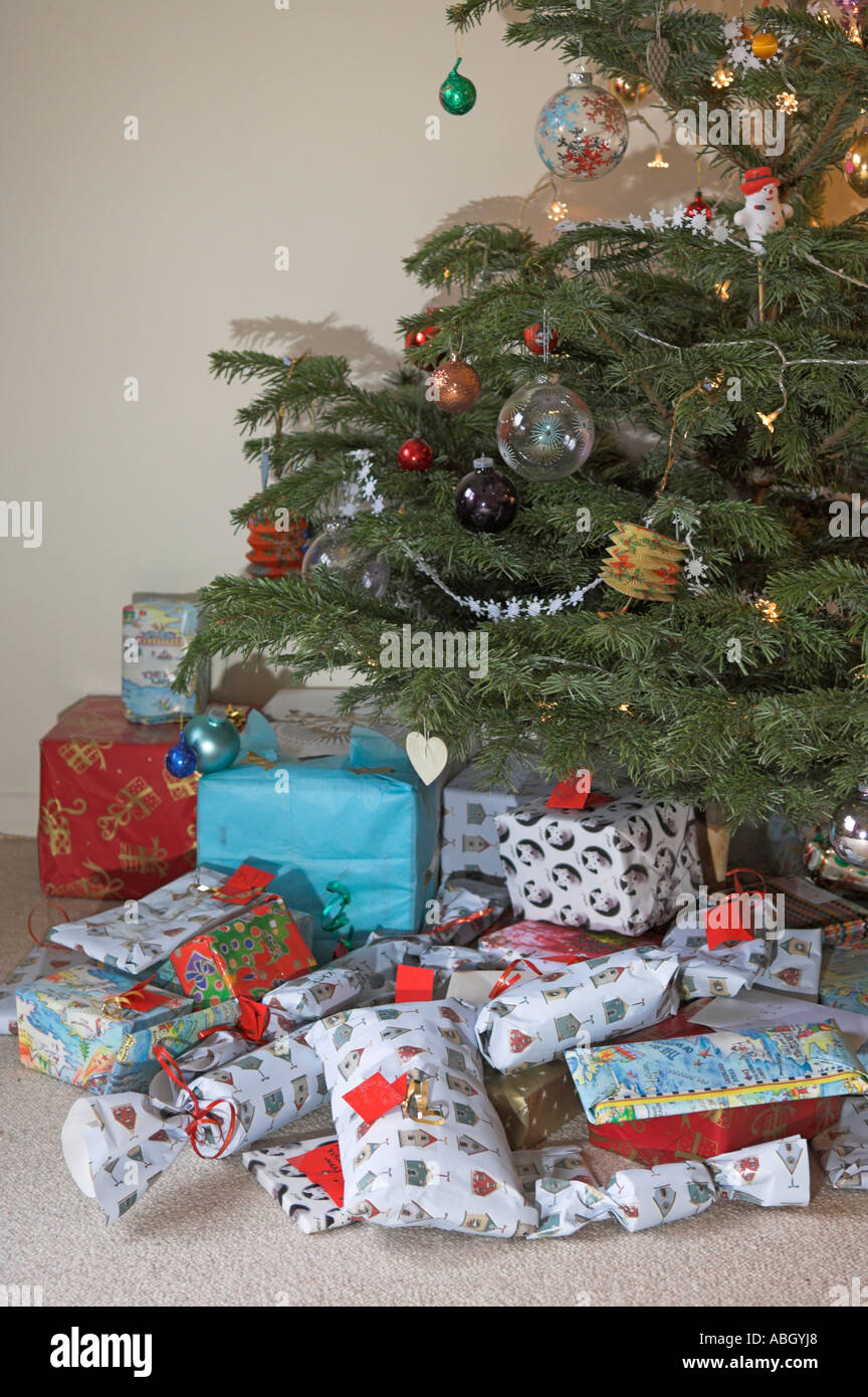 I regali di Natale sotto agli alberi con luci e presenta Foto Stock