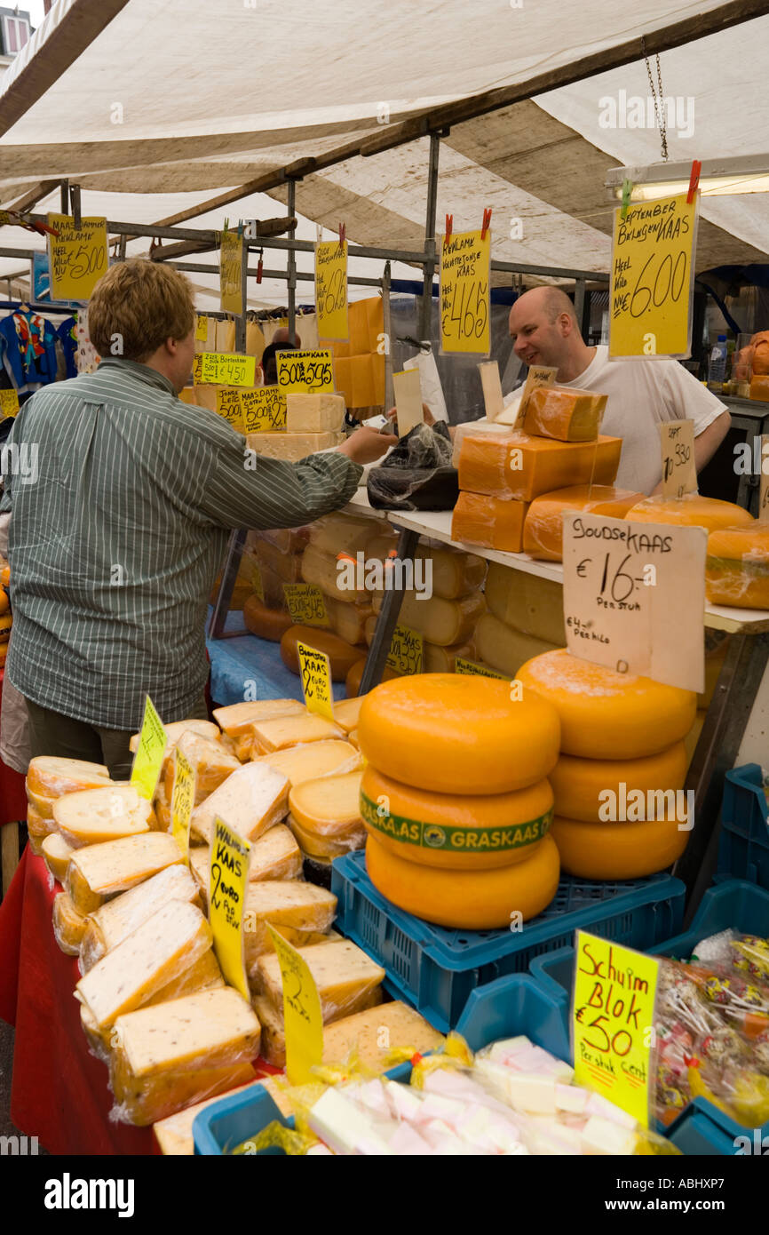 L'uomo acquistare il formaggio in un mercato del formaggio di stallo a Albert Cuypstraat mercato Olanda Amsterdam Paesi Bassi Foto Stock