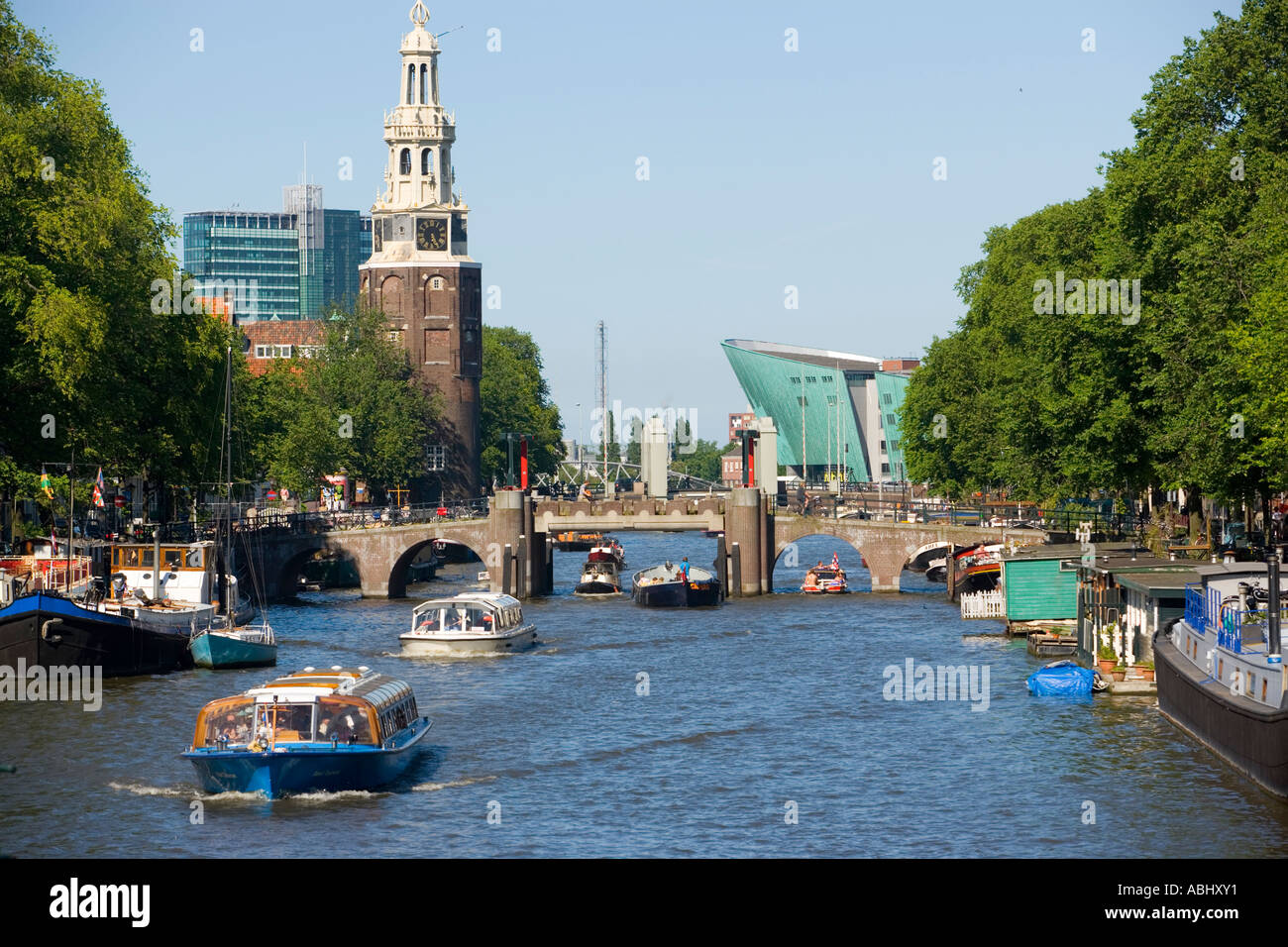 Vista sulla Oude Schans con barche da diporto a Montelbaanstoren torre di avvistamento e NEMO Museum Amsterdam Holland Olanda Foto Stock