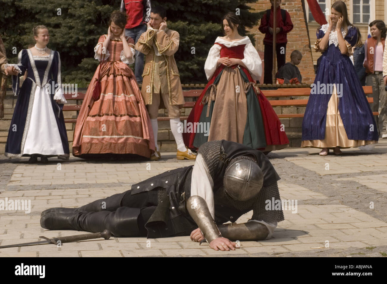 Combattimenti cavalieri in armatura e casco con la spada e guardare le donne in costumi di Sandomierz Polonia Foto Stock