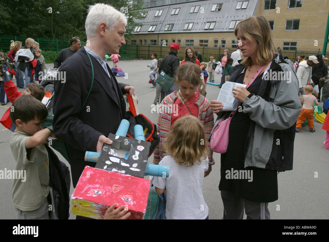 I genitori a raccogliere i loro figli alla fine della giornata scolastica, Betty Layward junior school di Londra, Regno Unito. Foto Stock