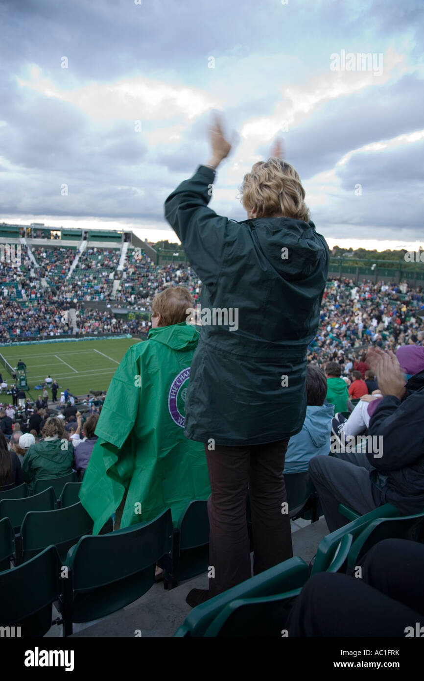 Donna spettatore battendo le mani durante la riproduzione a Centre Court Wimbledon Tennis Championship. Il torneo di Wimbledon. Regno Unito Foto Stock