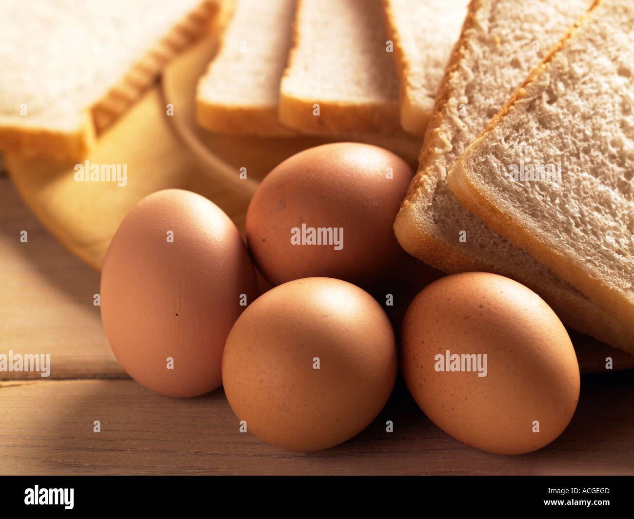 Paesaggio colpo di quattro uova con fette di pane bianco girato in doghe di legno con tavola calda illuminazione soleggiato Foto Stock