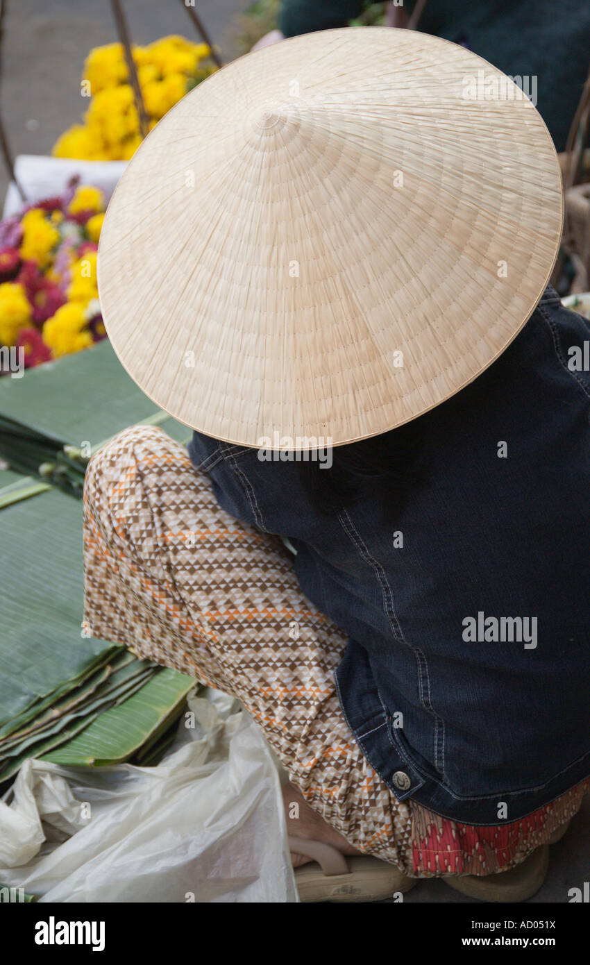 Donna che indossa cappello conico che vendono fiori Hoi An market Quang Nam Da Nang Provincia del Vietnam Foto Stock