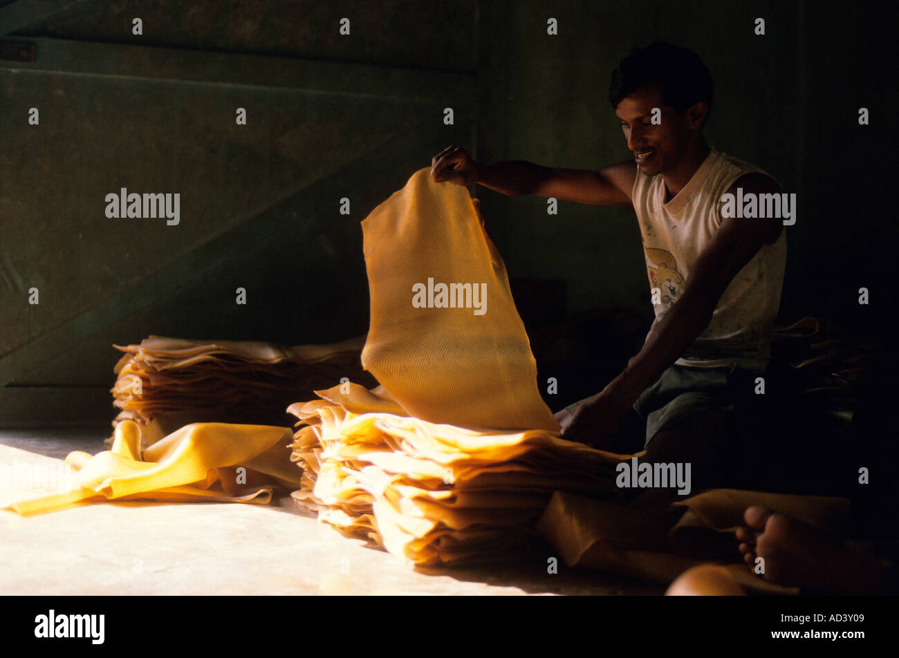 Trasformazione di materie il lattice in Malaysia lattice vulcanizzato viene ispezionata per verificare la presenza di oggetti estranei che sono tagliati fuori Foto Stock