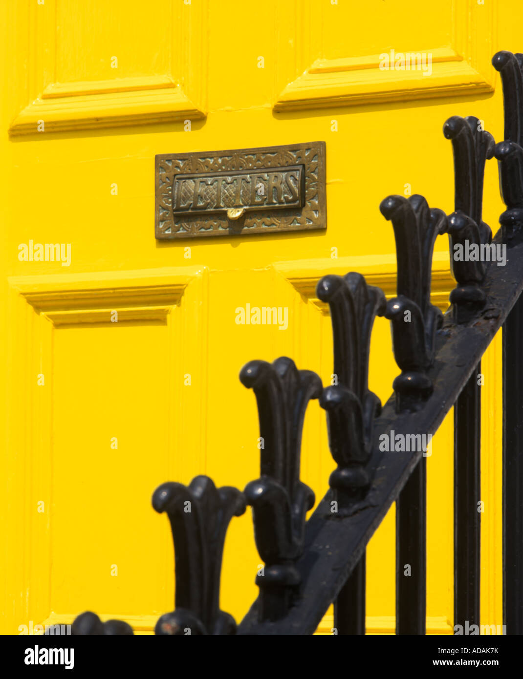 Dettaglio della porta giallo di un albergo di Londra incentrato su un insolito letter box Foto Stock