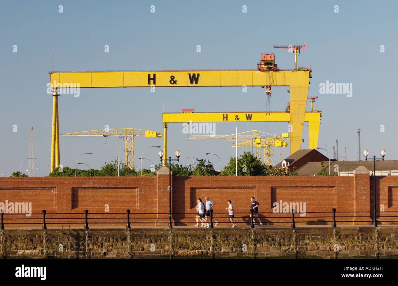 Belfast Attrazioni gru Sansone e Golia. Patrimonio di costruzione navale. Harland e Wolff cantieri, una volta che i mondi più grande. Gli uomini jogging Foto Stock