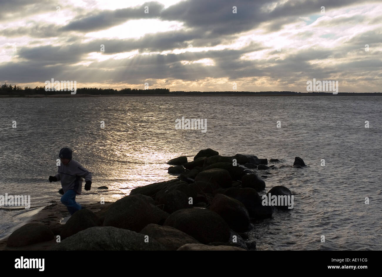 Costa del Mare del Nord e il sole che splende attraverso le nuvole scure, Danimarca Foto Stock