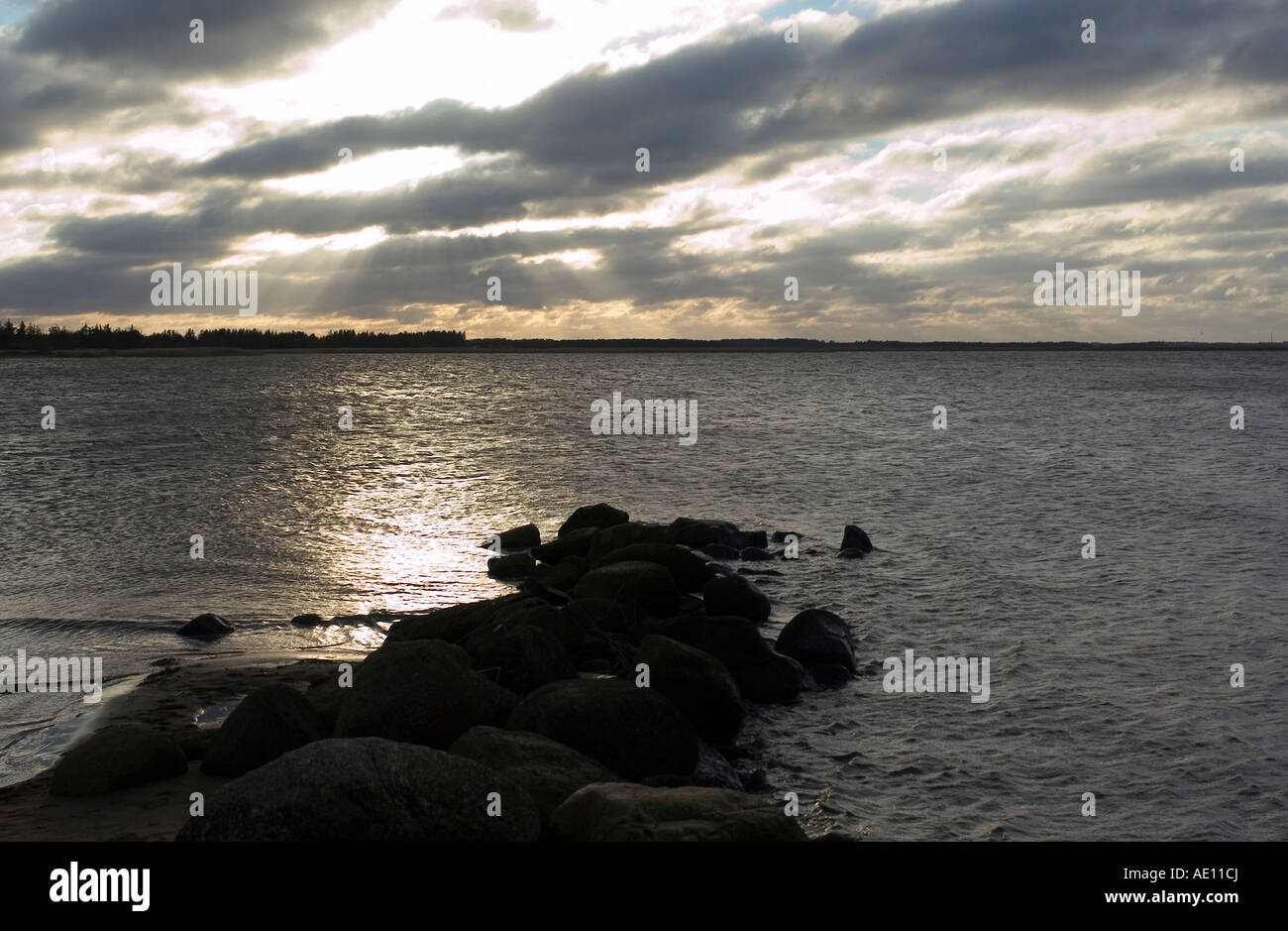 Costa del Mare del Nord e il sole che splende attraverso le nuvole scure, Danimarca Foto Stock