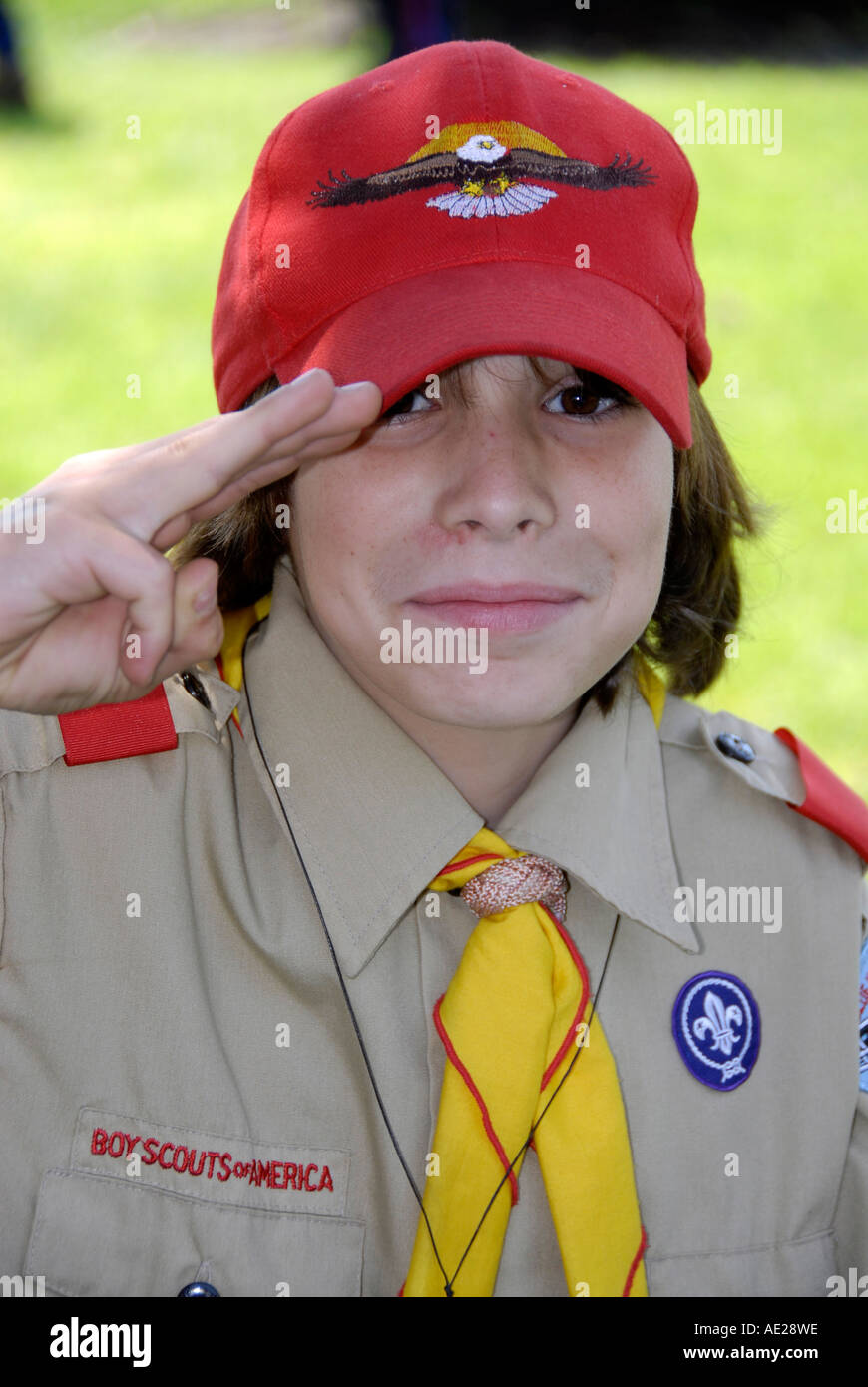 Boy Scout in uniforme esegue con tre dita in omaggio Foto Stock