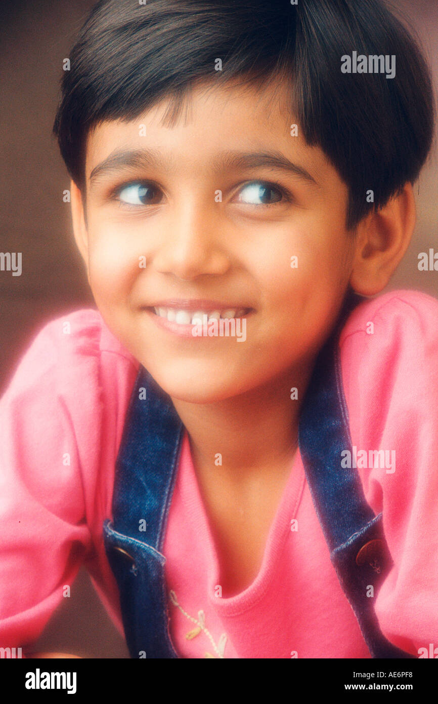 RHS70975 South Asian Indian giovane ragazzo che indossa il colore rosso T shirt blu e strisce di colore giacca con sorriso modello di rilascio 519 Foto Stock