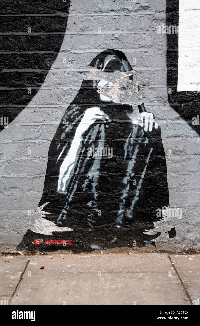 Jef Aerosol incollando su eine atti di vandalismo parete, Shoreditch, Londra Foto Stock