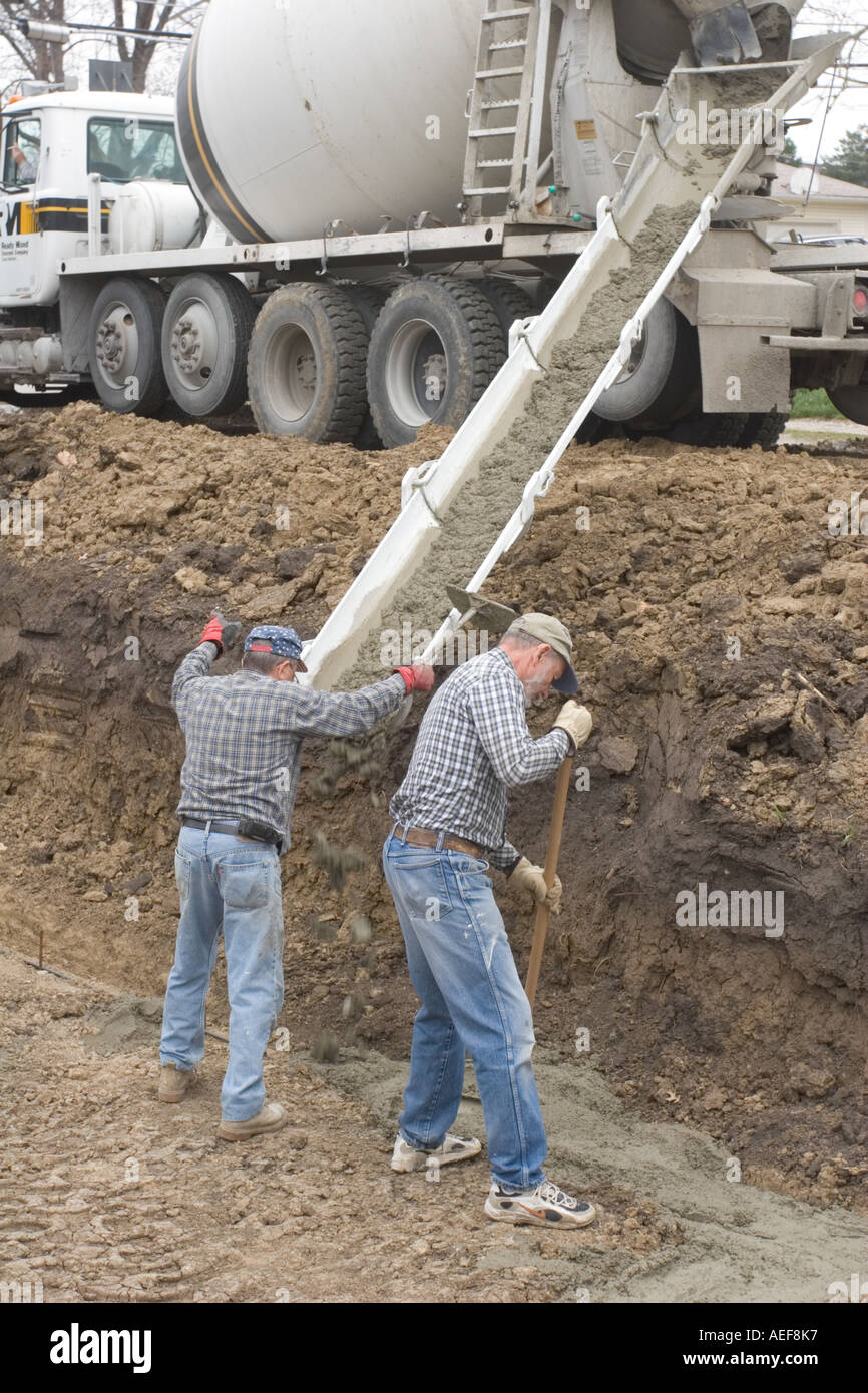 Volounteers versando la fondazione in un Habitat for Humanity sito dove una nuova casa sarà costruito per una famiglia meritevoli Foto Stock
