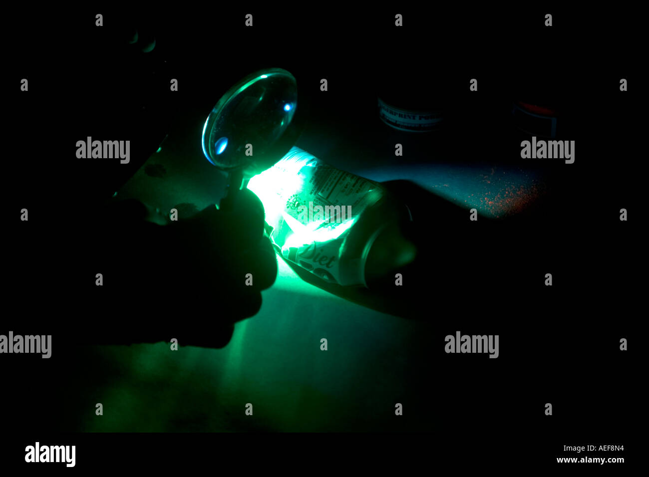 Ricerca di impronte digitali sotto luce fluorescente. Foto Stock