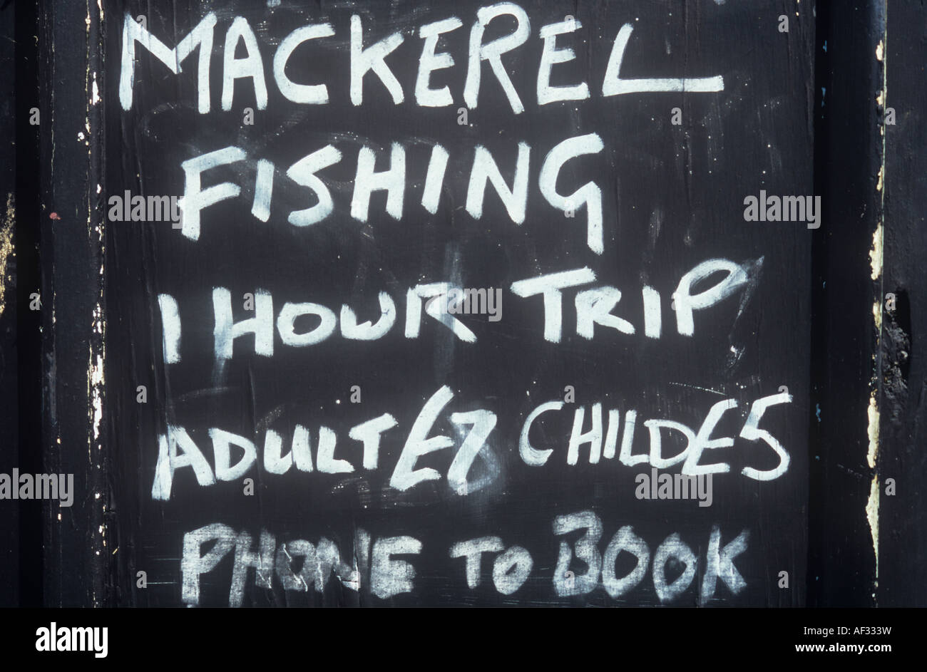 Lavagna con gesso bianco lettering capitale pubblicità la pesca dello sgombro 1 ora di viaggio per adulti £7 bambino £5 telefono per prenotare Foto Stock